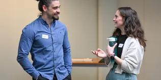 Two people talking at an event.