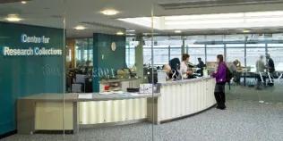 An image of the Centre for Research Collections Helpdesk, with the reading room behind it