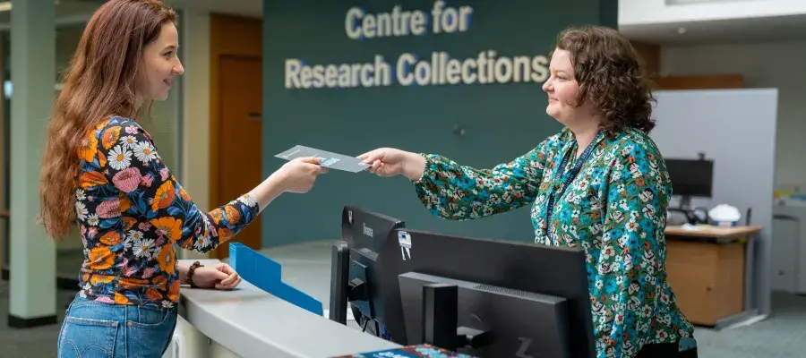 Image of staff helping a visitor at reception