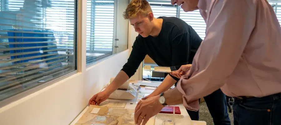 This image shows a student with a lecturer discussing collections.