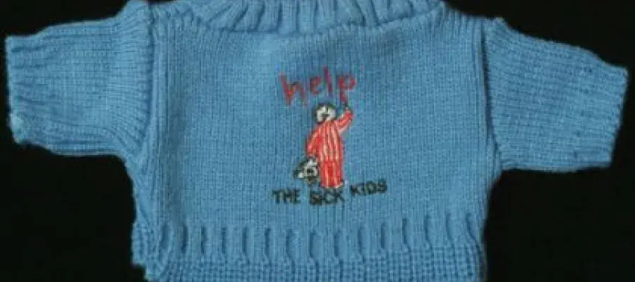 Blue jumper from TASK (To Aid Sick Kids, 1989 - 1992). Text reads: help, THE SICK KIDS