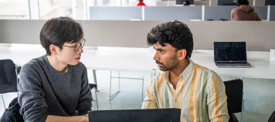 Students working together in the Library on a computer