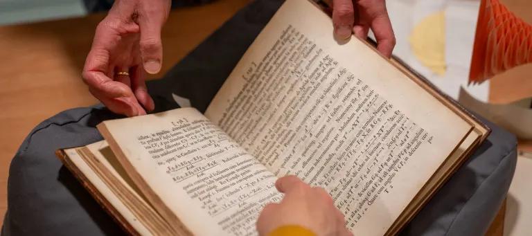 Close up of hands and a book