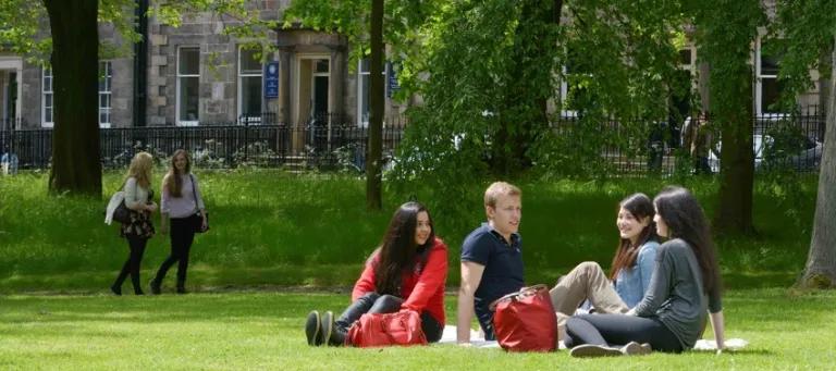 students sitting in the Meadows