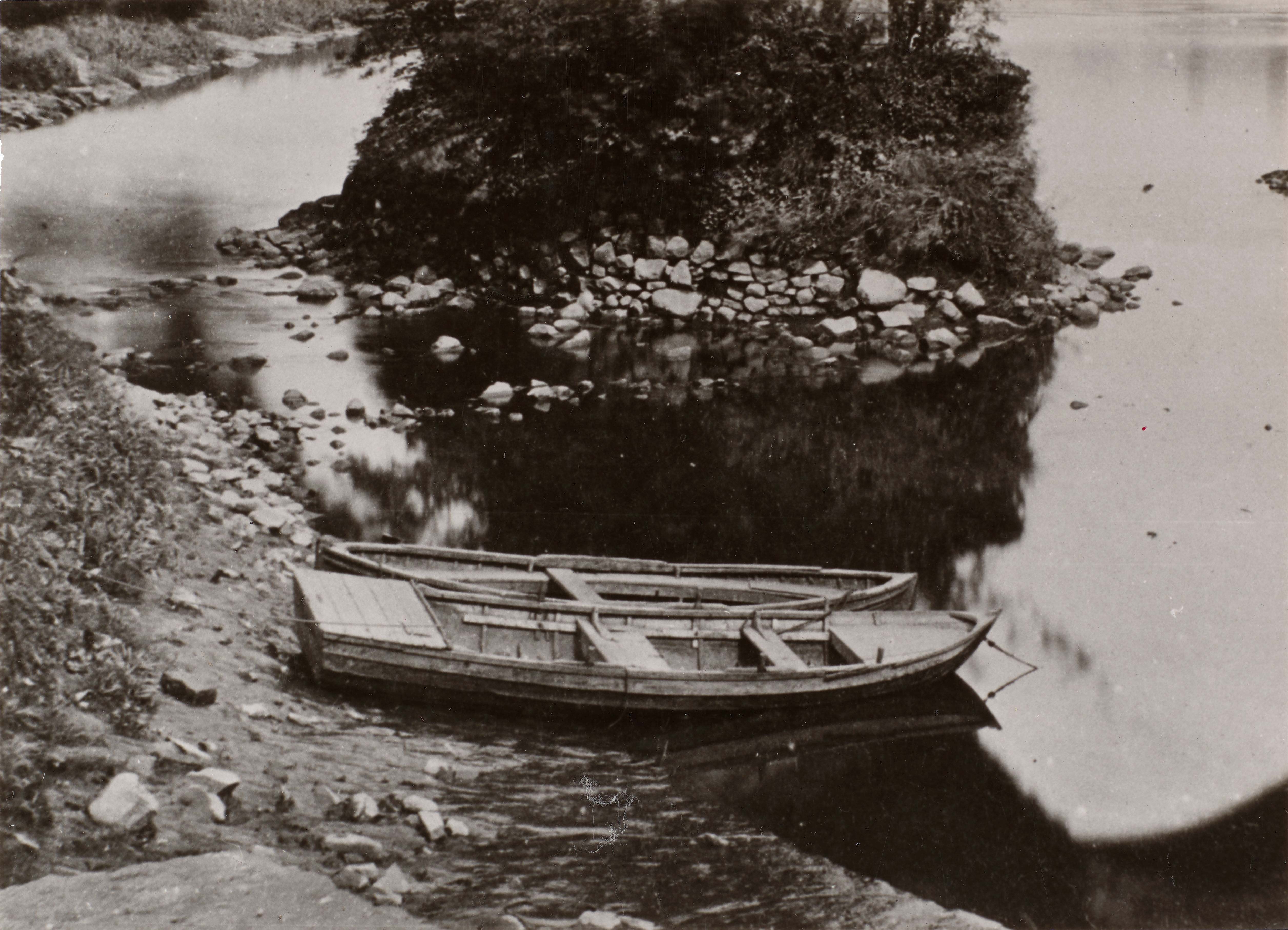 a small boat on the bank of a river