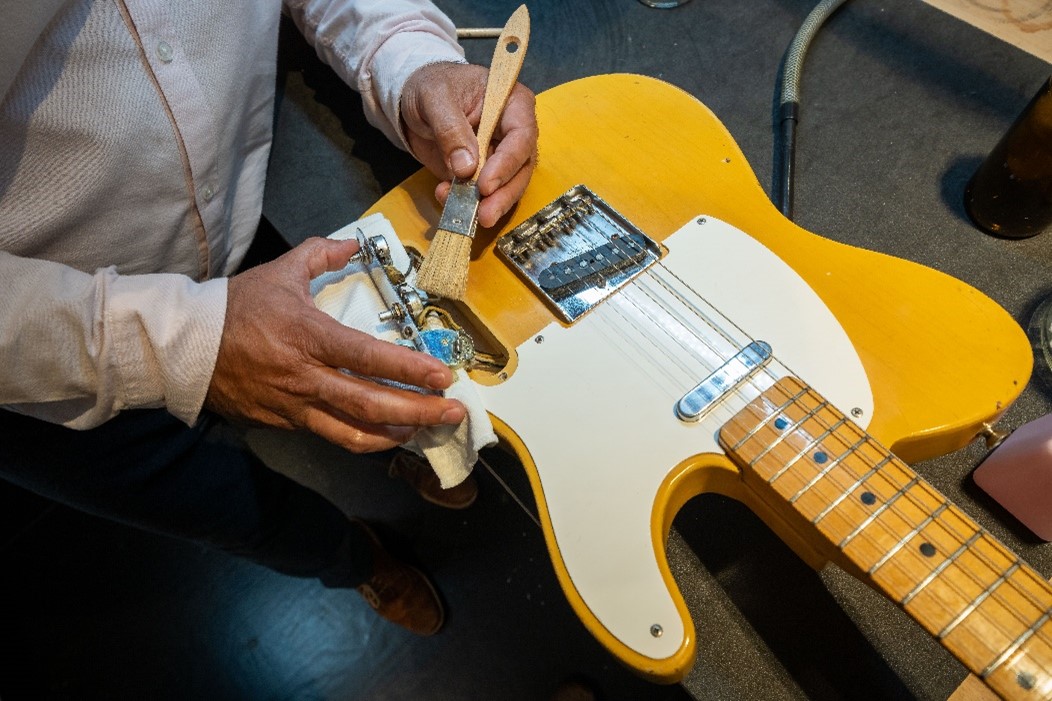 Conservation work on a guitar